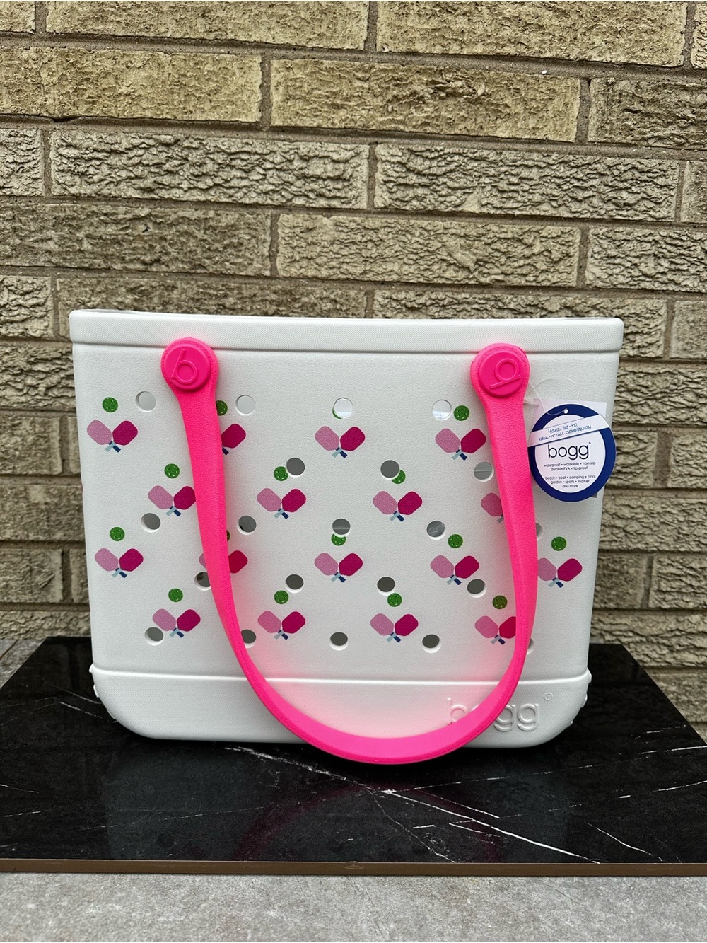 Bogg Bag featuring a playful pickleball pattern and vibrant hot pink handles